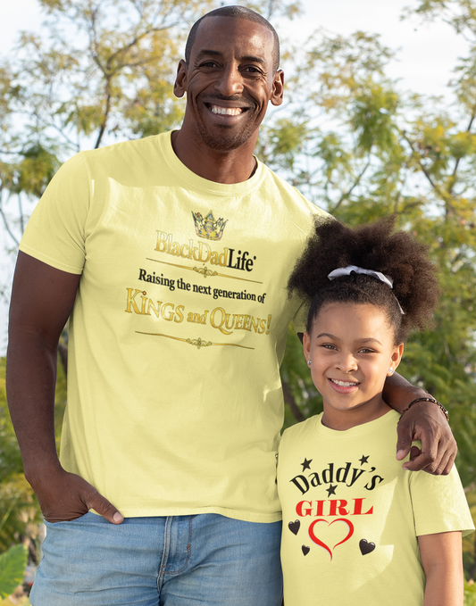 Man and young girl standing outdoors wearing matching yellow t-shirts.