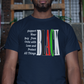 Man wearing a dark blue t-shirt with text and colors in an urban setting