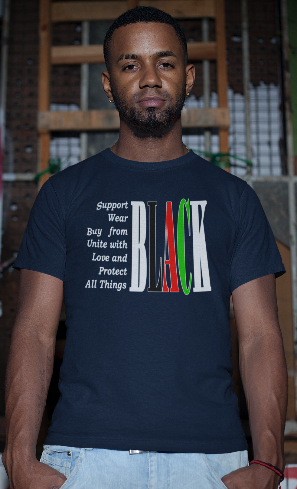 Man wearing a dark blue t-shirt with text and colors in an urban setting