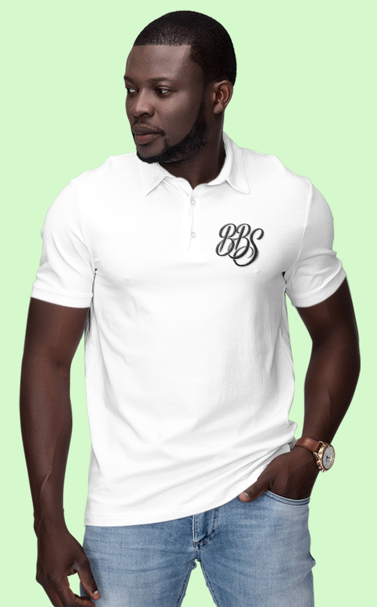 Man wearing a white polo shirt with a logo on a gray background