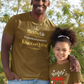 Man and young girl wearing matching brown t-shirts in a park