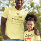 Man and young girl standing outdoors wearing matching yellow t-shirts.