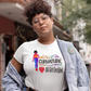 Person wearing a t-shirt with a graphic design on a city street