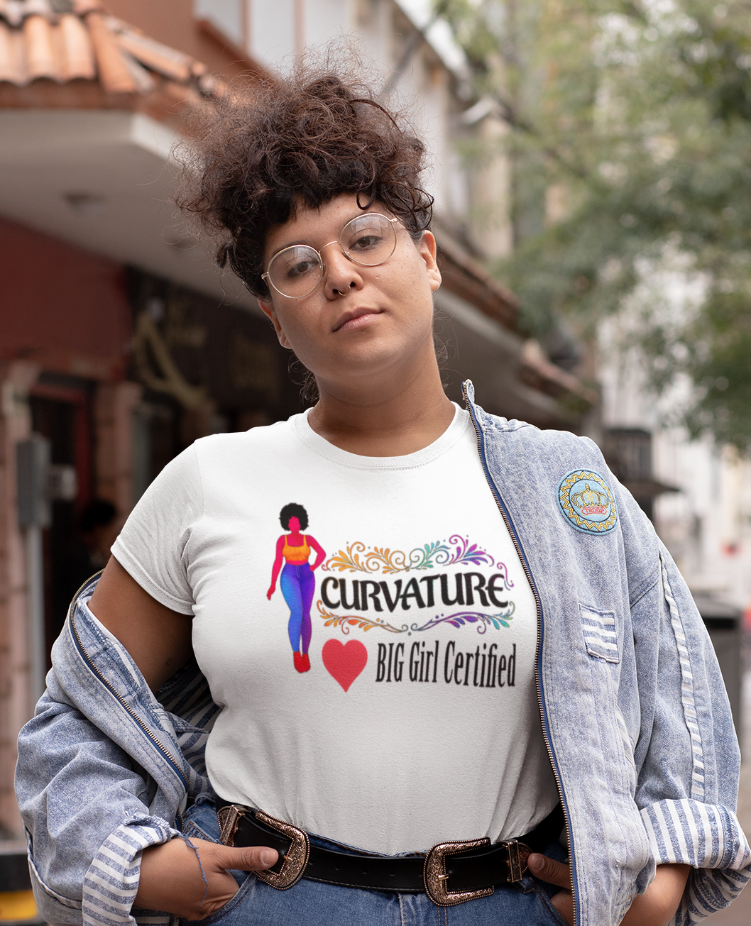 Person wearing a t-shirt with a graphic design on a city street