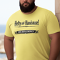 Man wearing a navy blue t-shirt with text saying Hefty and Handsome with BIG Boy Energy underneath, standing by a stone wall with a scenic background.