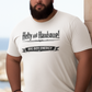 Man wearing a navy blue t-shirt with text saying Hefty and Handsome with BIG Boy Energy underneath, standing by a stone wall with a scenic background.