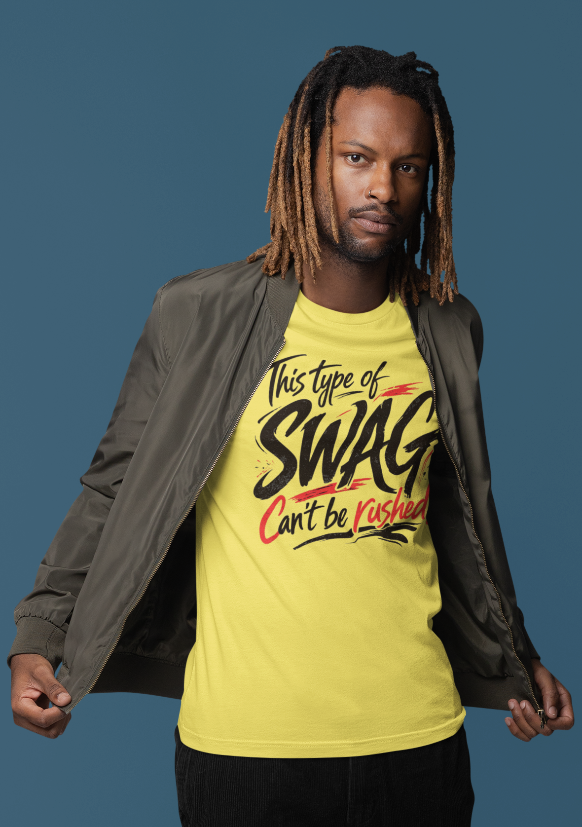 Man wearing a yellow t-shirt with text, black pants, and white shoes on a blue background