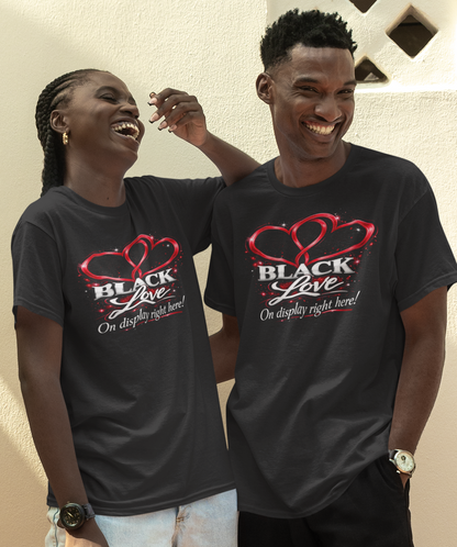 Two people wearing matching black t-shirts with 'Black Love' design outdoors.