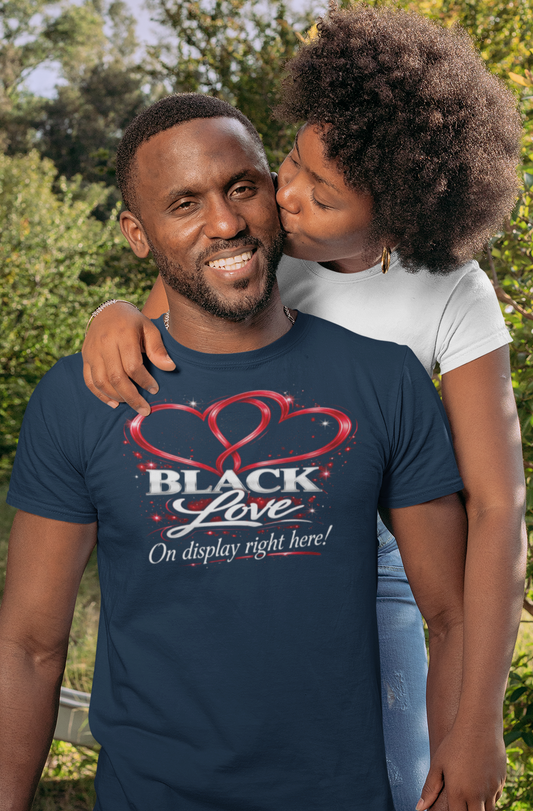 Man wearing a navy blue t-shirt with 'Black Love' design, standing outdoors with a child.
