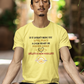 Man in a yellow shirt meditating outdoors on a wooden deck.