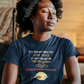 Person sitting in a meditative pose wearing a blue t-shirt with text and graphics.