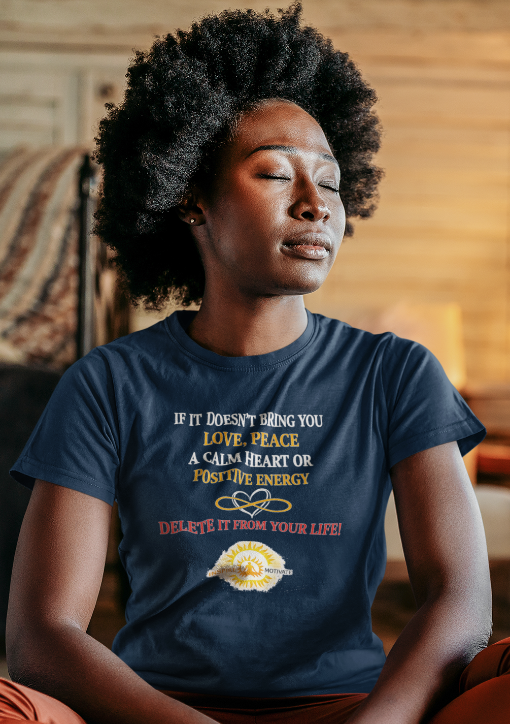Person sitting in a meditative pose wearing a blue t-shirt with text and graphics.