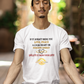 Man meditating on a mat with a motivational quote t-shirt in an outdoor setting
