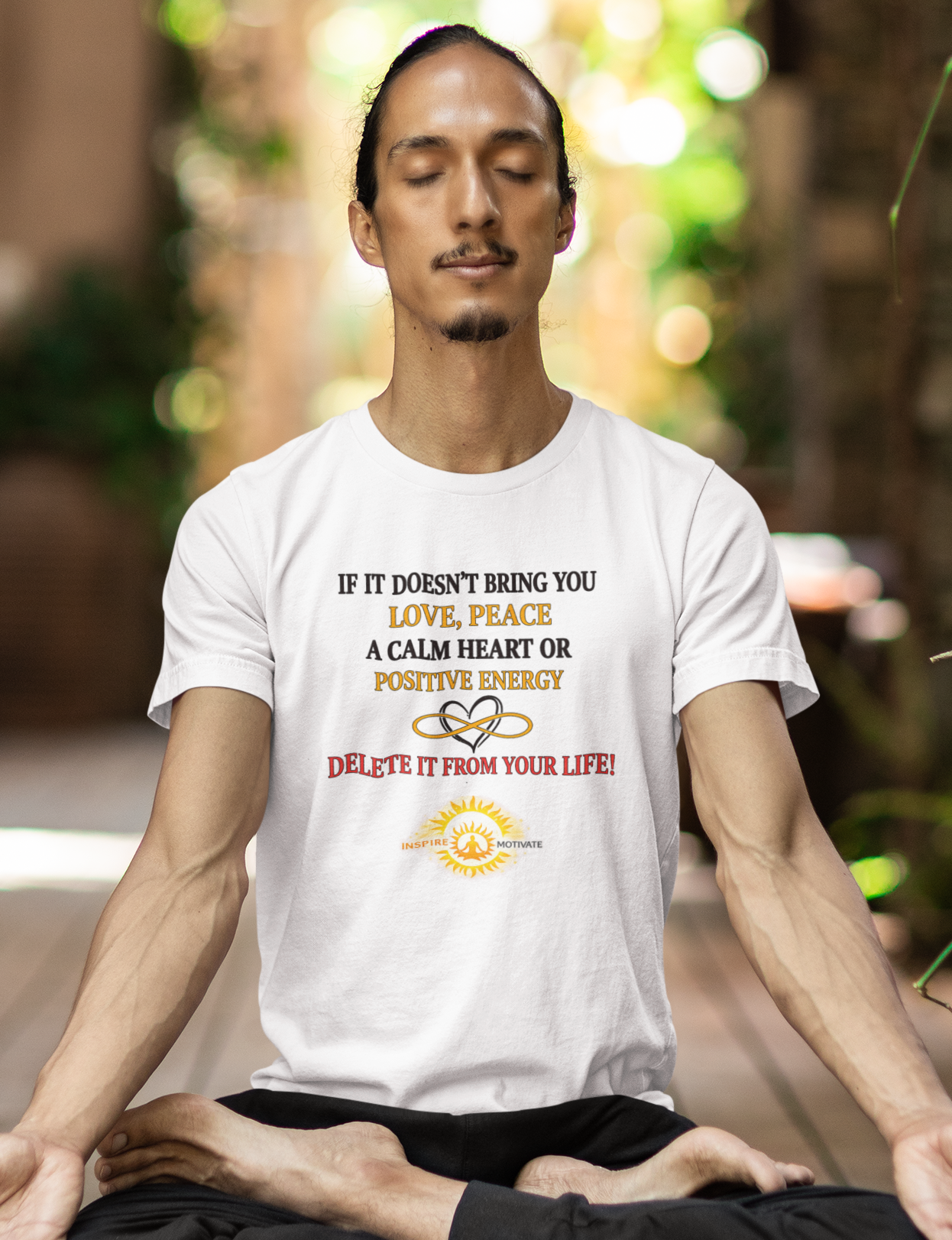 Man meditating on a mat with a motivational quote t-shirt in an outdoor setting