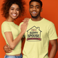 Two people wearing matching light green t-shirts with a house graphic and text on an orange background