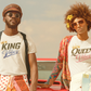 Two people standing in front of a vintage car with 'King' and 'Queen' shirts.