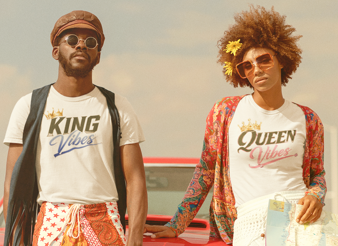 Two people standing in front of a vintage car with 'King' and 'Queen' shirts.