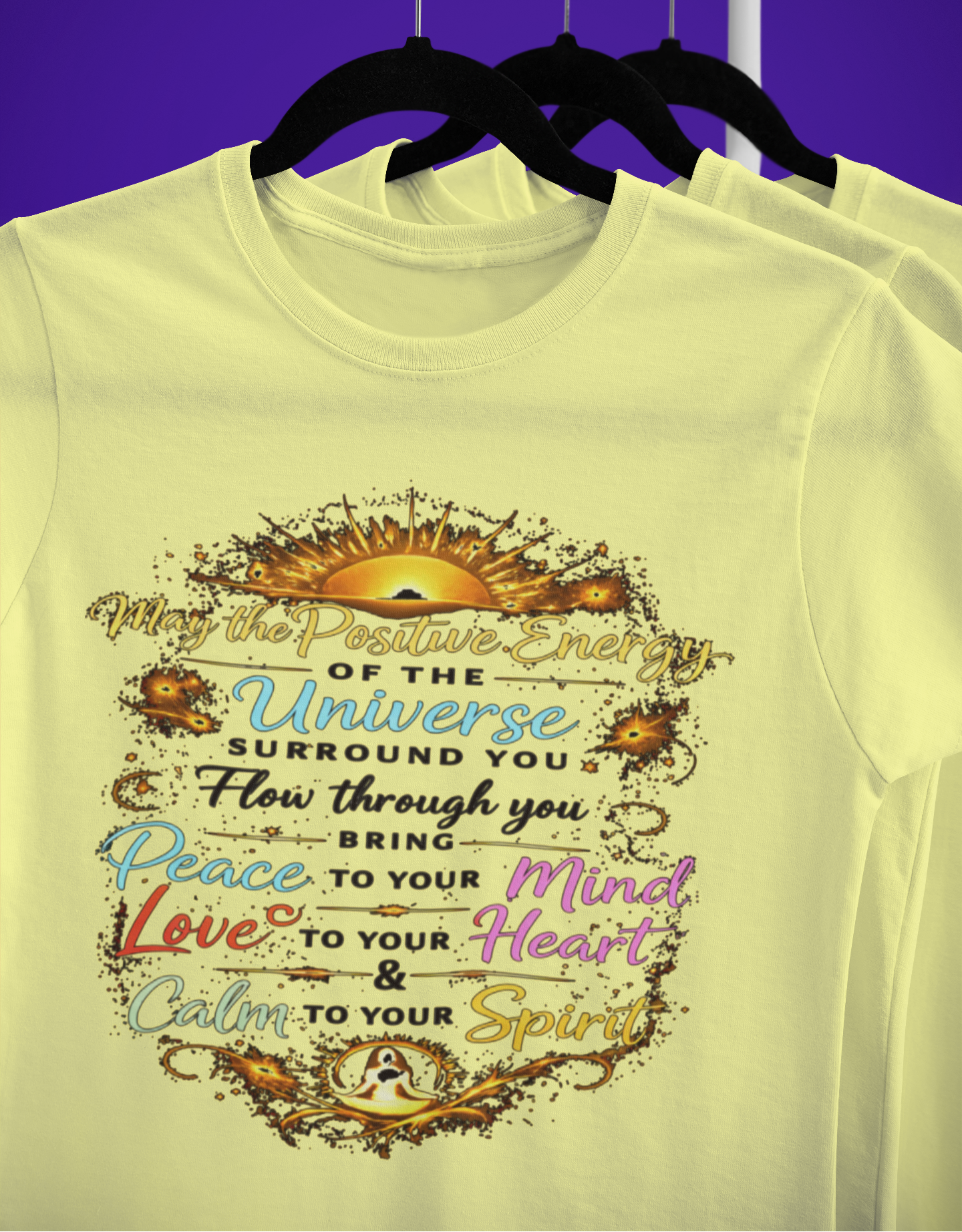 Yellow t-shirt with motivational quote on a hanger against a purple background